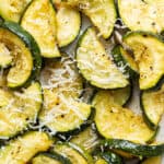 Close up of roasted zucchini topped with parmesan cheese.