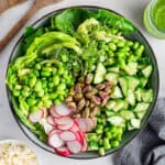 Green goddess salad ingredients in bowl before tossing