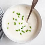 Bowl of vegan sour cream topped with chives