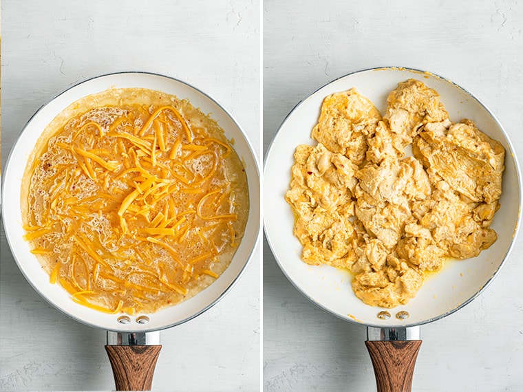 A pan with uncooked scrambled eggs in it with shredded cheese just added, next to a pan with finished scrambled eggs and cheese