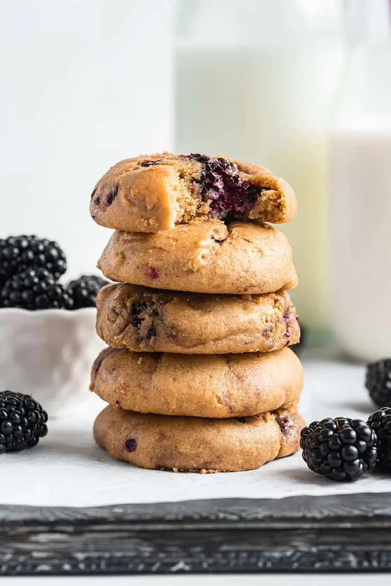 Stack of blackberry cookies, with top cookie bitten