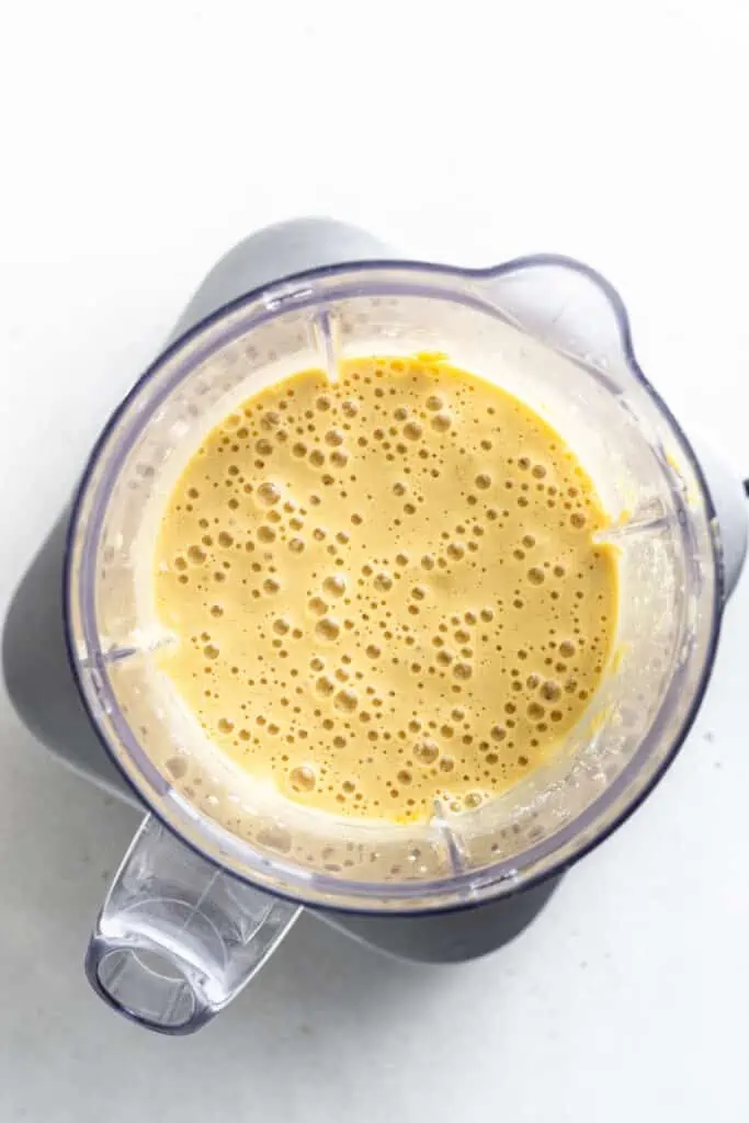 These protein pancakes are fluffy and flavorful, made with 6 ingredients in the blender. Gluten-free, dairy-free, and meal prep-friendly! Protein pancake batter inside a blender.
