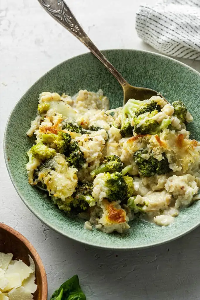 A plate of broccoli casserole with a fork in it