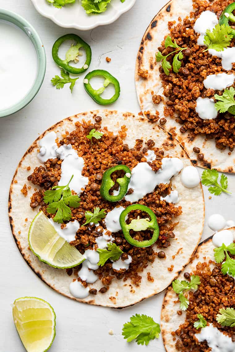 This easy vegan taco meat is made with lentils and quinoa. Unbelievably delicious, super healthy, and ideal for meal prep! Overhead view of quinoa and lentil vegan tacos