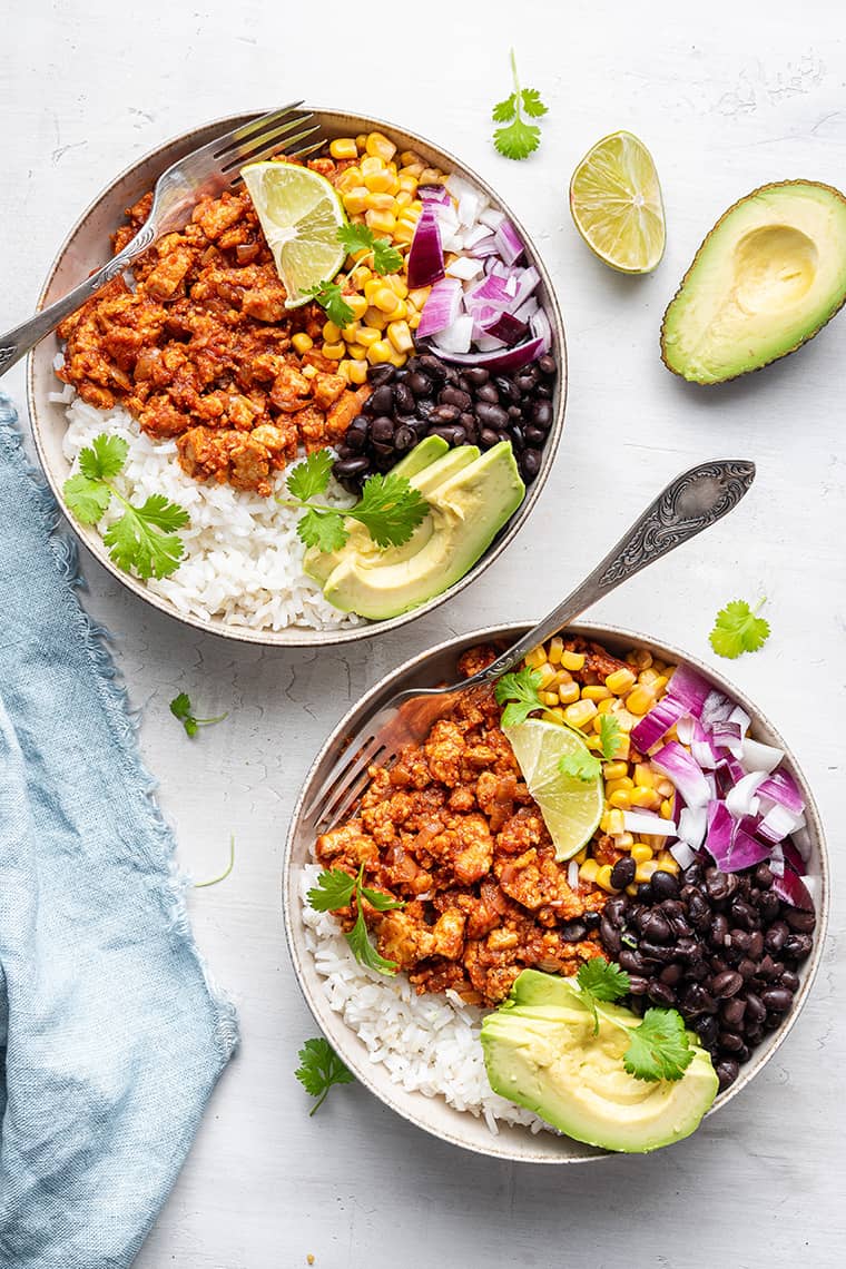 If you always order the vegan sofritas from Chipotle, you're going to love this recipe for making smoky, flavorful tofu sofritas at home! Overhead view of two sofritas burrito bowls