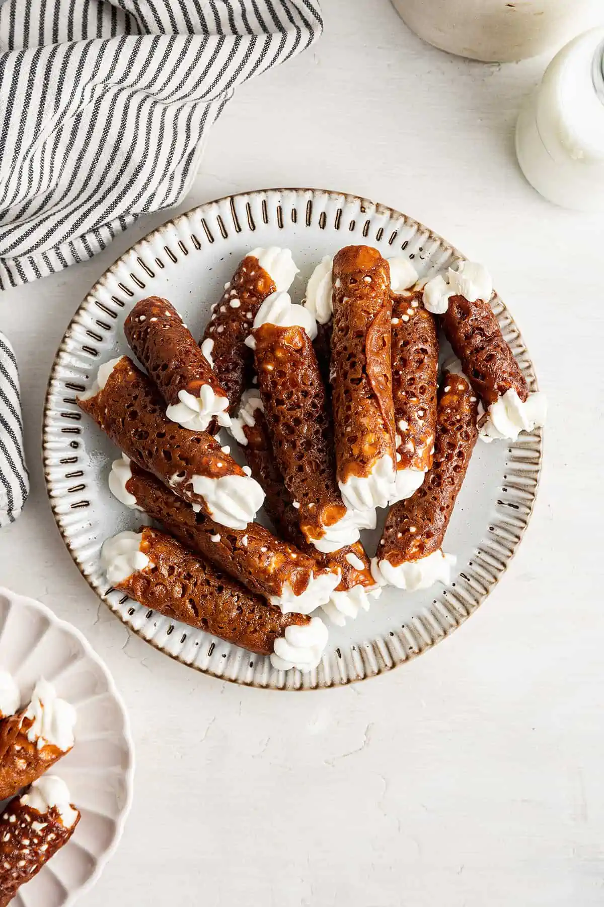 Overhead view of a plate with a pile of brandy snaps on it