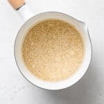 Quinoa simmering in a saucepan with water.