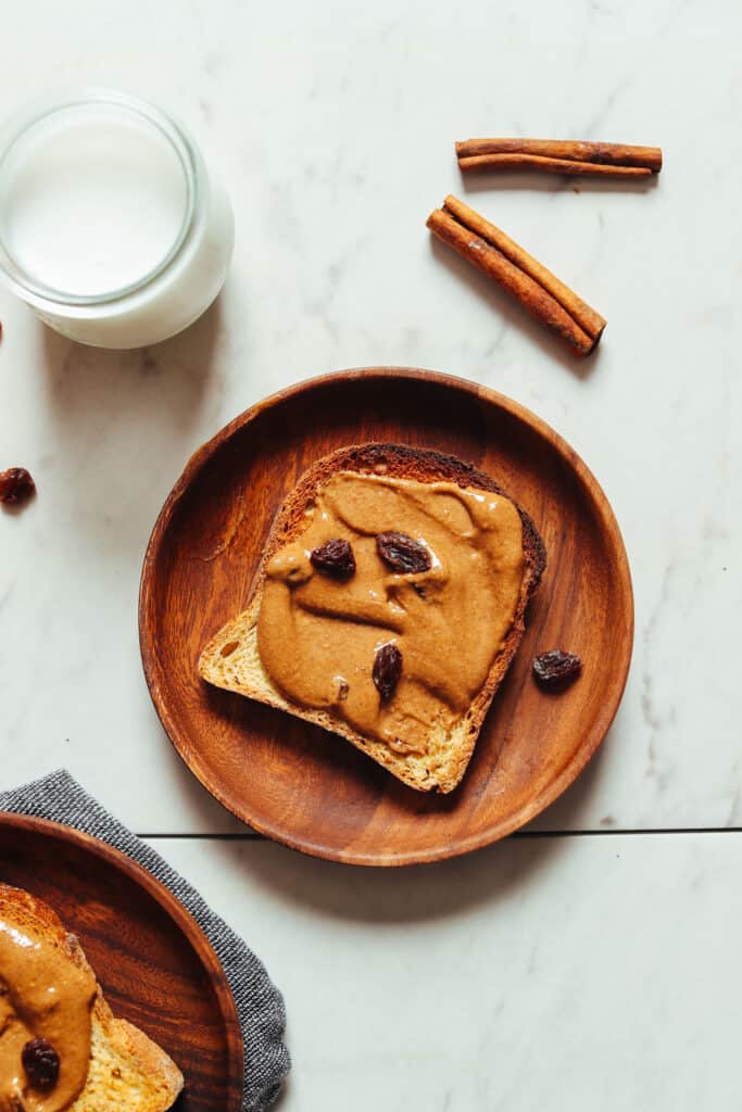 cinnamon raisin peanut butter spread on a slice of toast