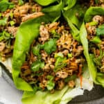 Close up of a chicken lettuce wrap on a tray of lettuce wraps