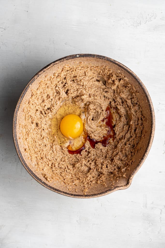 These dairy-free espresso cookies are chewy, packed with chocolate and espresso flavor, and topped with the perfect touch of finishing salt. Even better, it only takes about 20 minutes to make! A mixing bowl of coconut sugar and vegan butter beaten together, with an egg and vanilla extract on top.