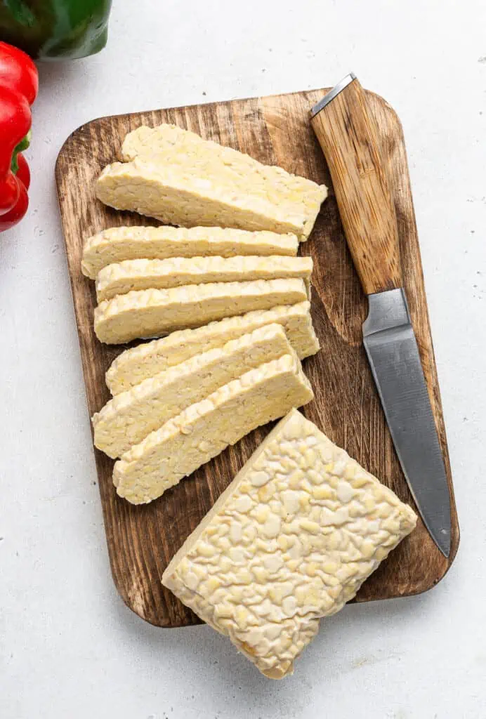 overhead of sliced tempeh on a wood cutting board