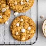 Overhead view of white chocolate chip and macadamia nut cookies chilling on a wire rack