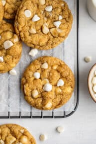 Overhead view of white chocolate chip and macadamia nut cookies chilling on a wire rack