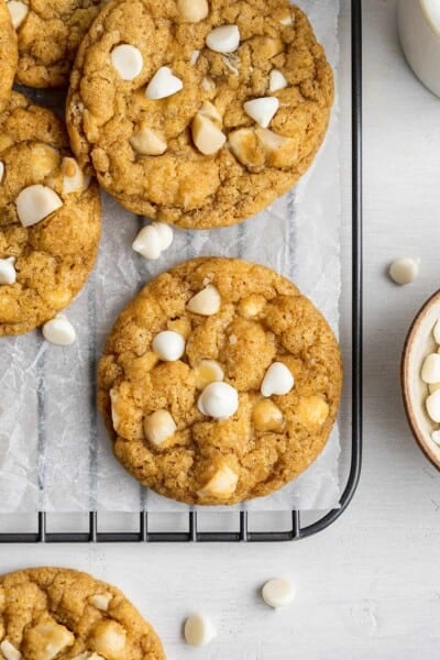 Overhead view of white chocolate chip and macadamia nut cookies chilling on a wire rack