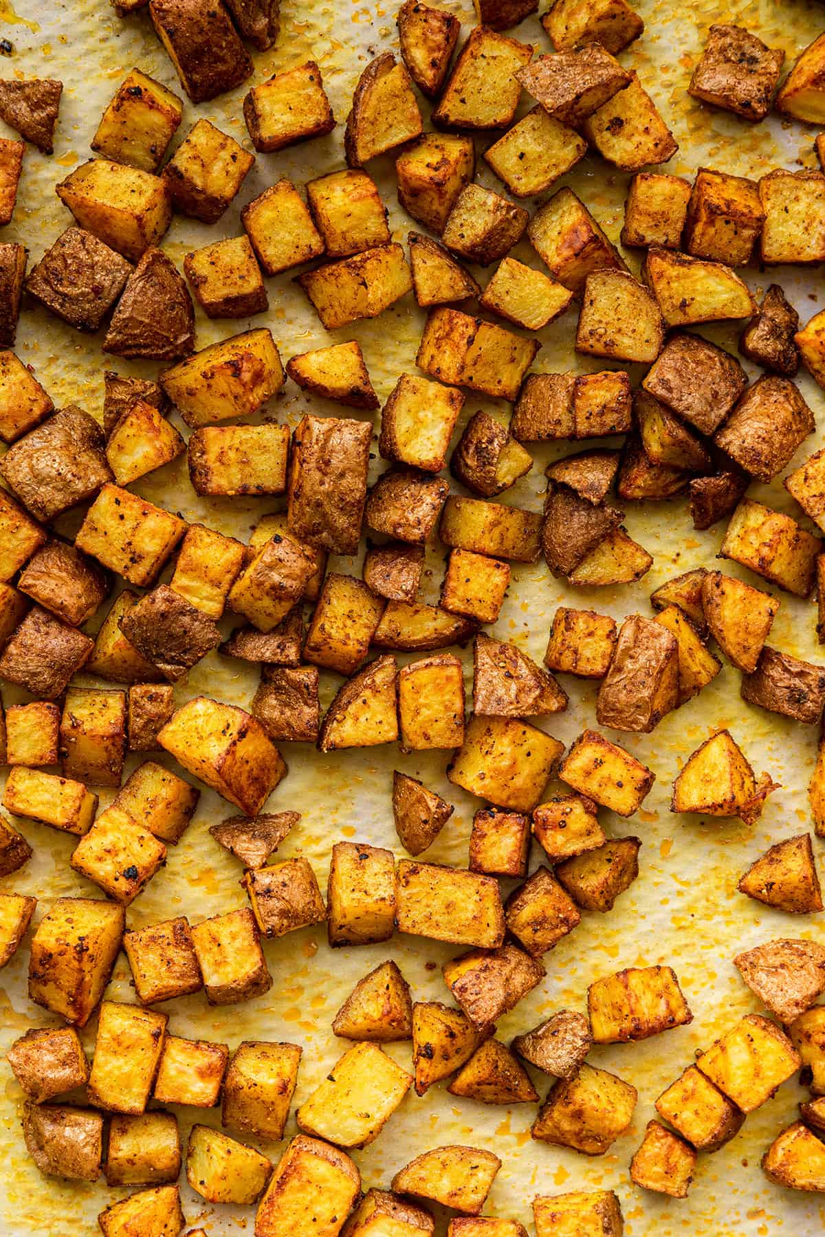 Overhead view of breakfast potatoes on a baking sheet