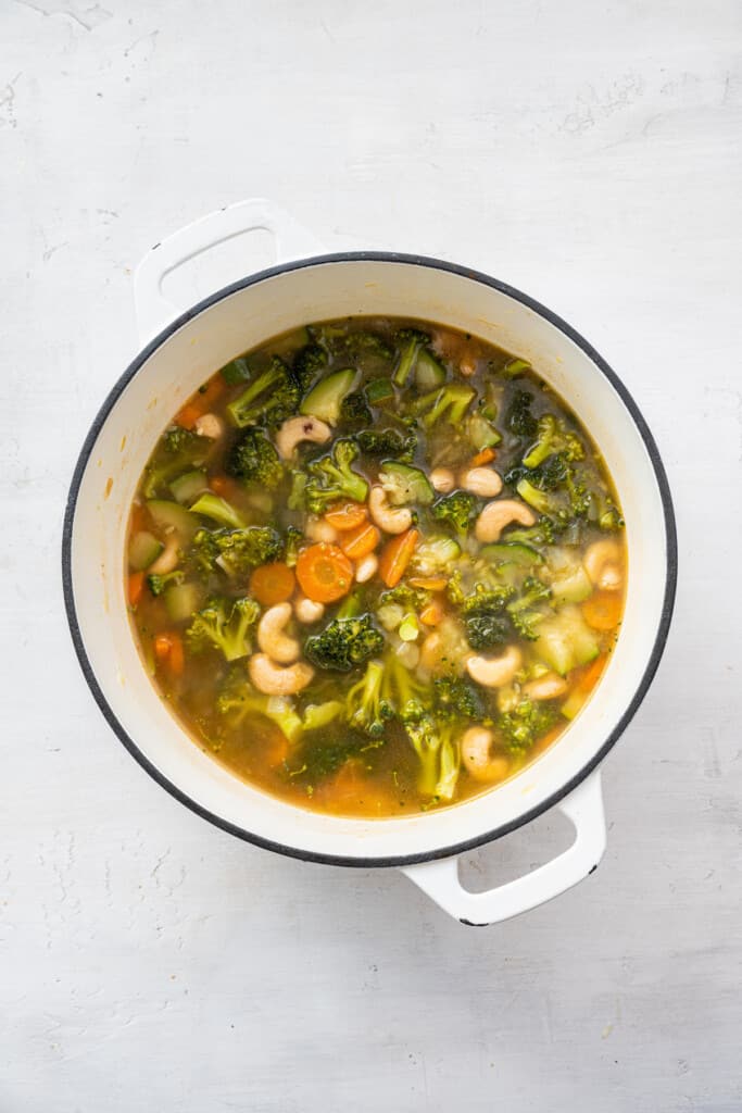 This creamy vegan broccoli soup is rich and silky without dairy. It's packed with savory veggies and ready in one pot in an hour or less! vegan creamy broccoli soup-7