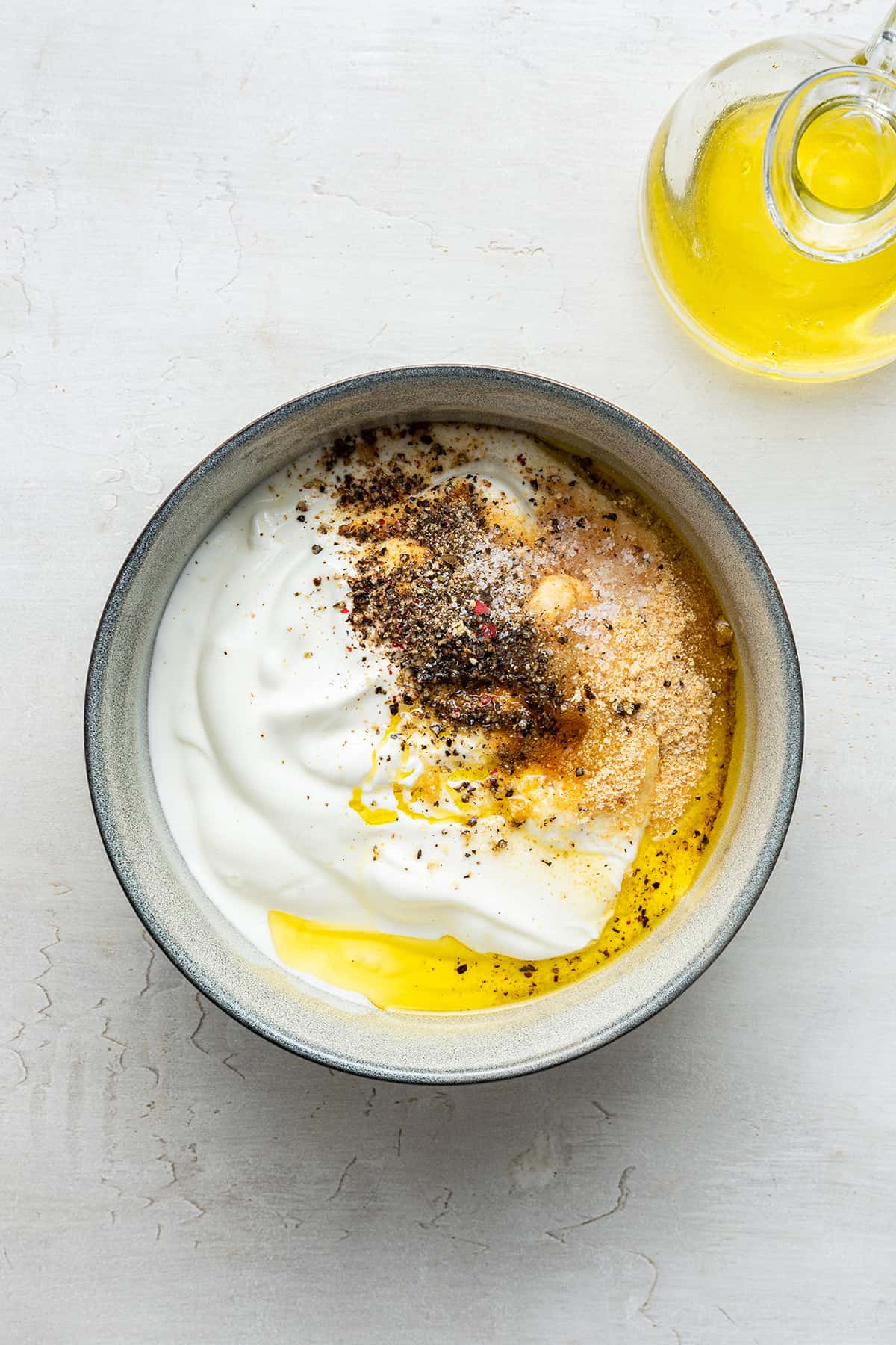 Overhead view of Greek yogurt dip ingredients in bowl before whisking