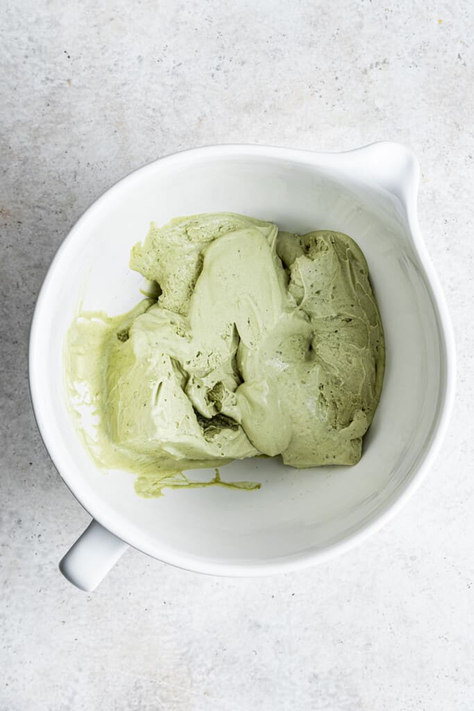 Overhead view of matcha ice cream in a stand mixer bowl