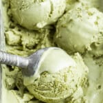 Close up of an ice cream scoop scooping balls of ice cream