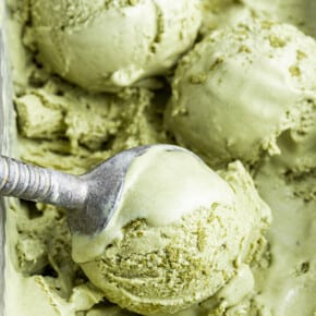 Close up of an ice cream scoop scooping balls of ice cream