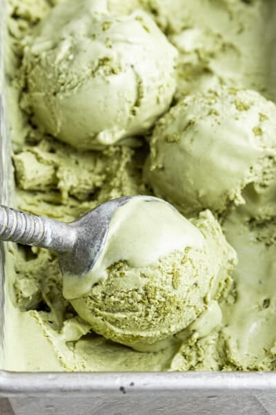 Close up of an ice cream scoop scooping balls of ice cream