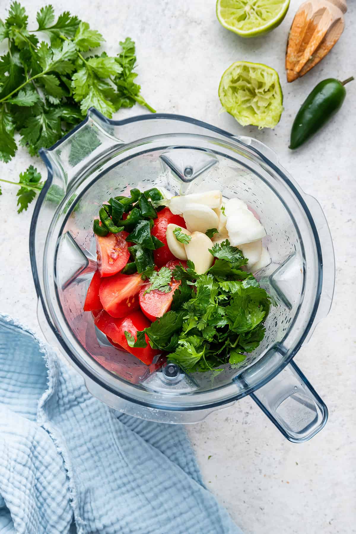 Overhead view of salsa roja ingredients in blender