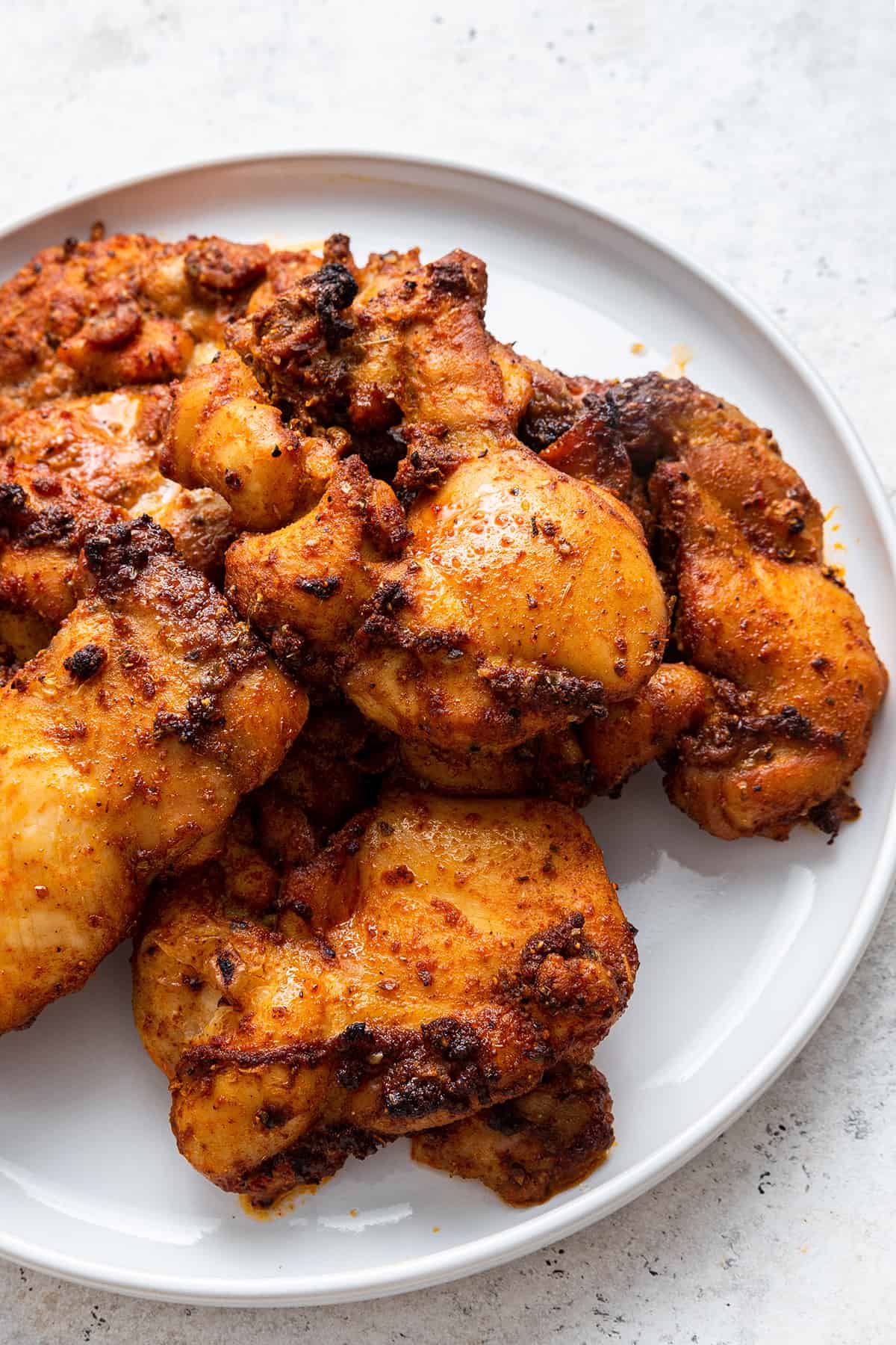 Blackened chicken thighs on plate