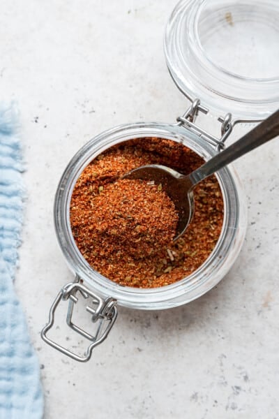 Spoon in open jar of blackened seasoning