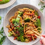 Overhead view of chopsticks in bowl of vegetable lo mein