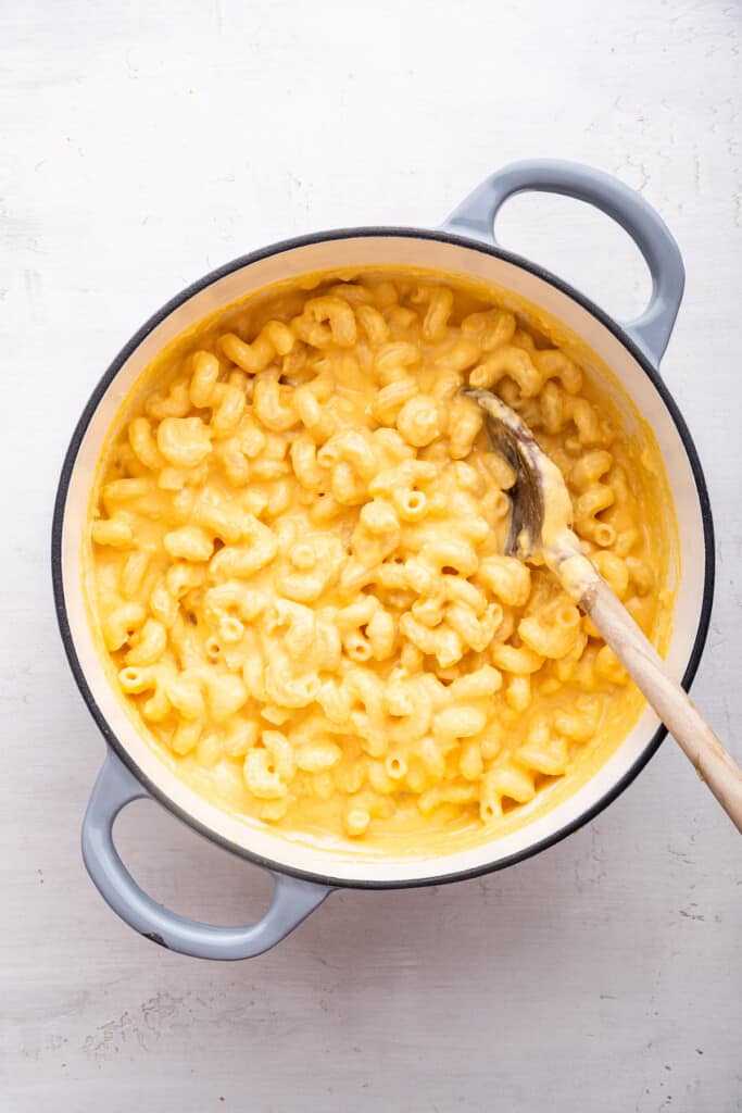 Overhead view of butternut squash mac and cheese with wooden spoon