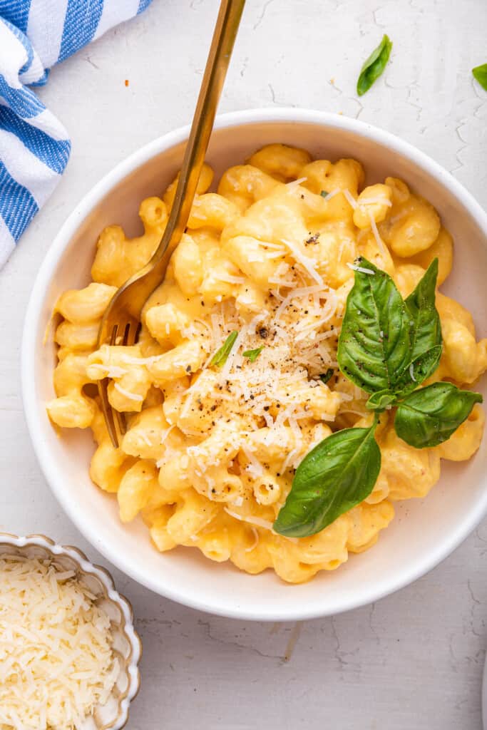 Overhead view of butternut squash mac and cheese in bowl with fork