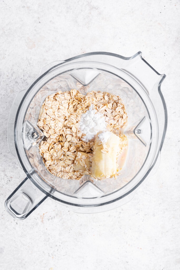 Overhead view of oatmeal banana pancake ingredients in blender