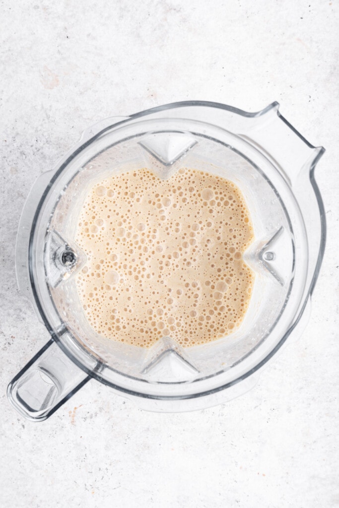 Overhead view of oatmeal banana pancake batter in blender