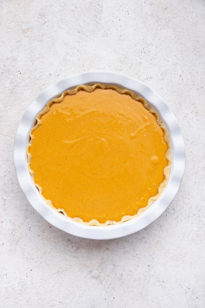 Overhead view of unbaked gluten-free pumpkin pie