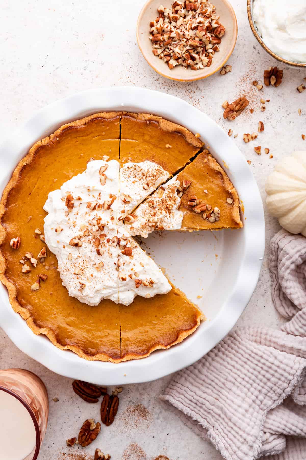 Overhead view of sliced gluten-free pumpkin pie with one piece removed