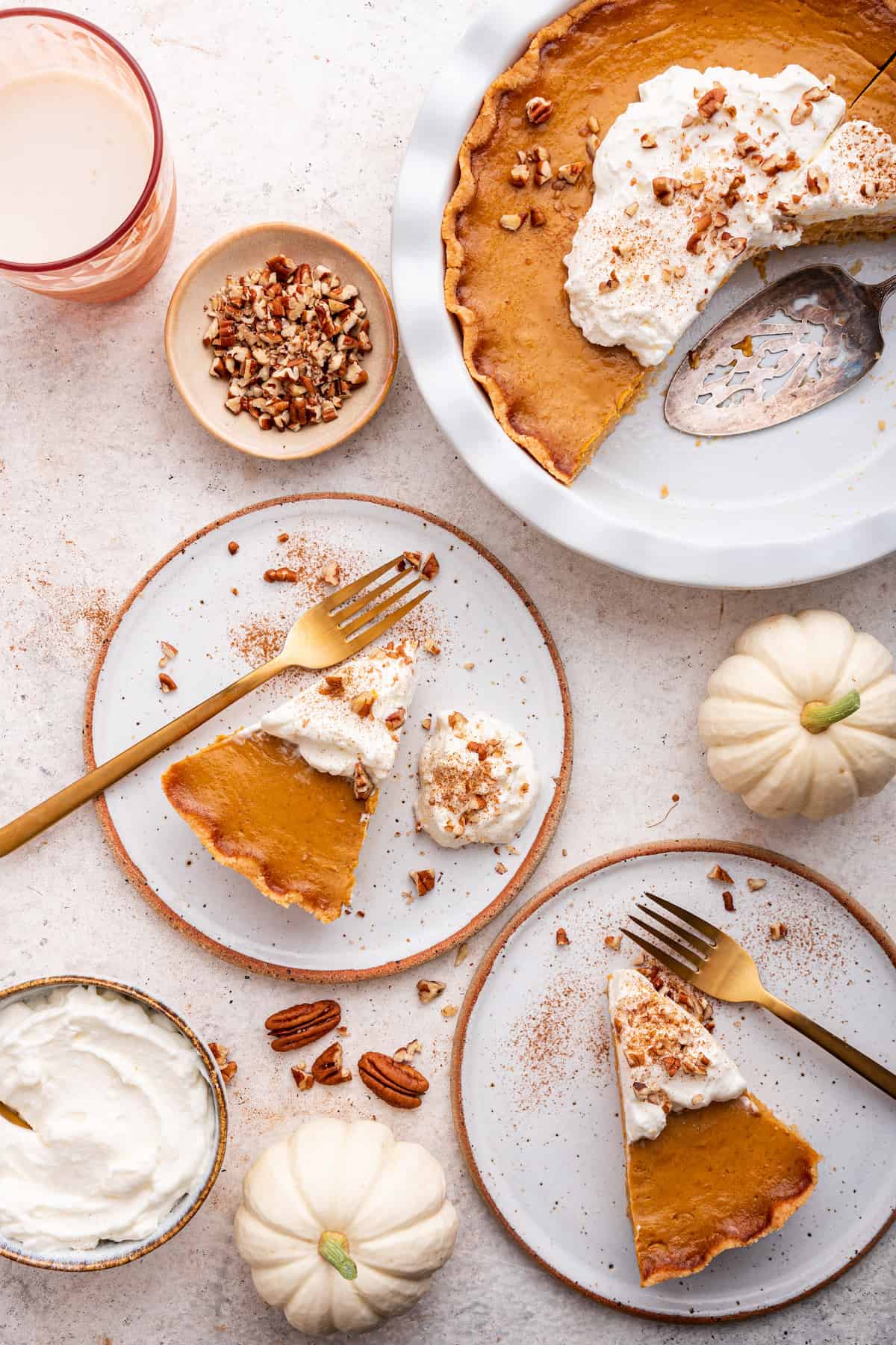 Overhead view of gluten-free pumpkin pie slices on two plates and remaining pie in pan