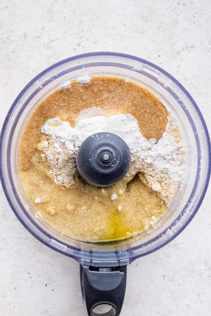 Overhead view of gluten-free pie crust ingredients in food processor bowl