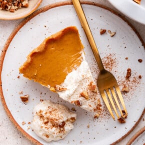 Overhead view of gluten-free pumpkin pie on plate with gold fork