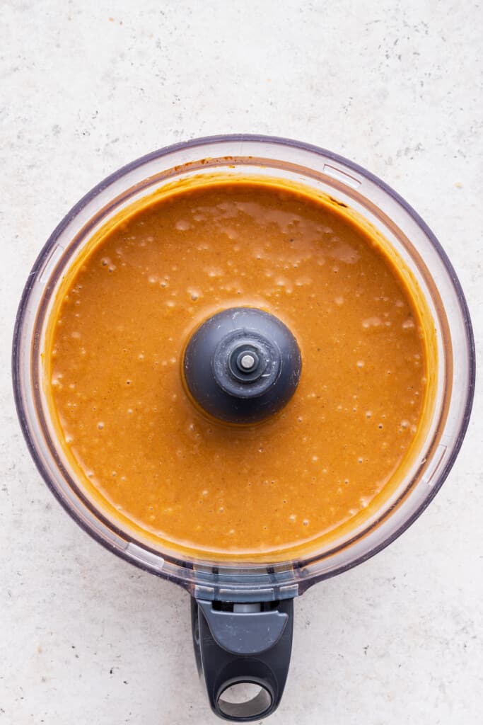 Overhead view of pumpkin pie filling in food processor bowl