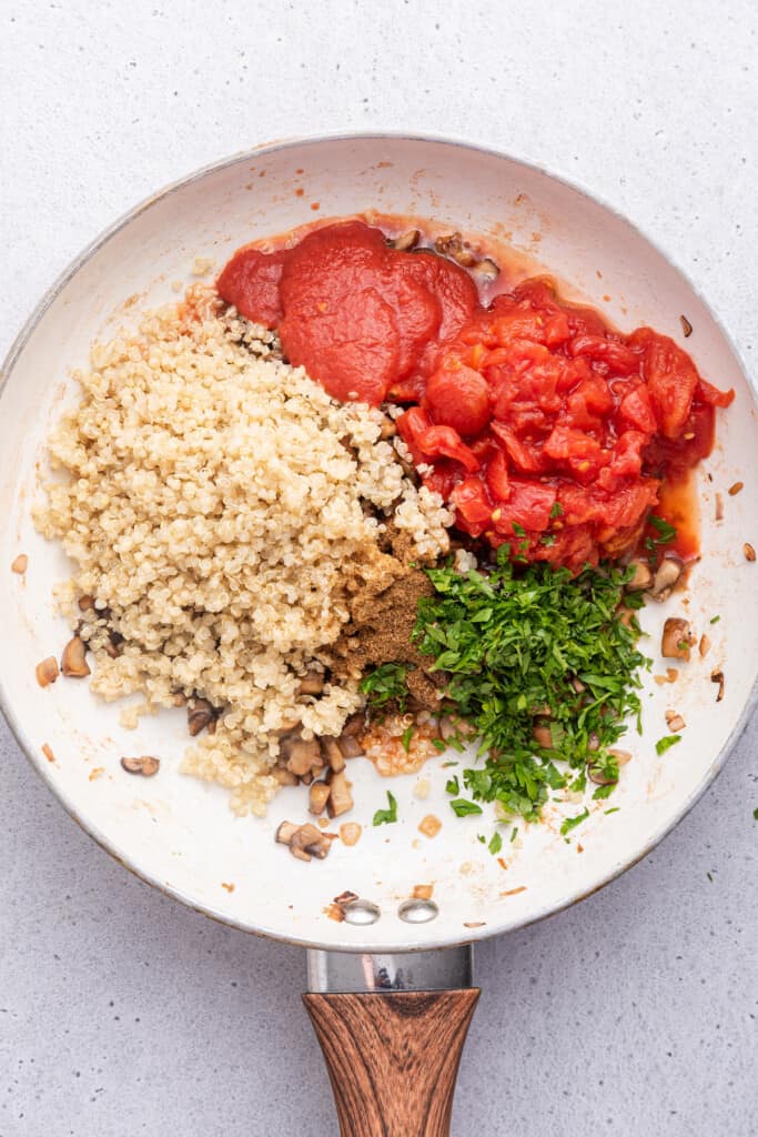 Overhead view of ingredients for quinoa filling in skillet