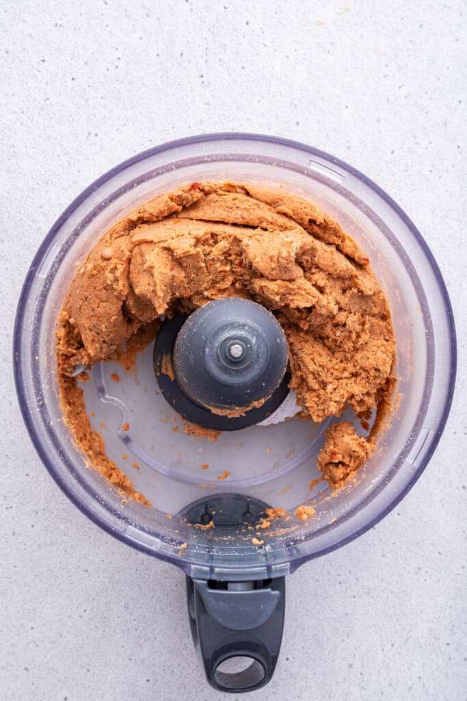 Overhead view of bean meatball mixture in food processor bowl