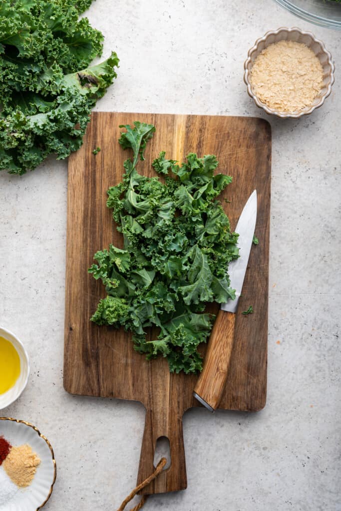Overhead view of kale on cutting board with knife