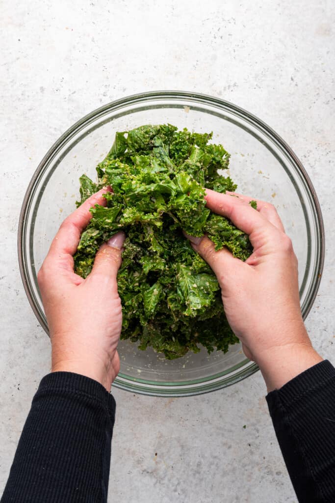 Hands in bowl of kale