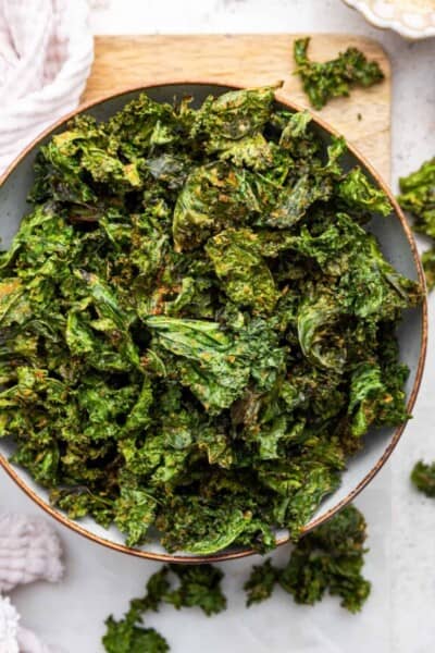 Overhead view of crispy air fryer kale chips in bowl
