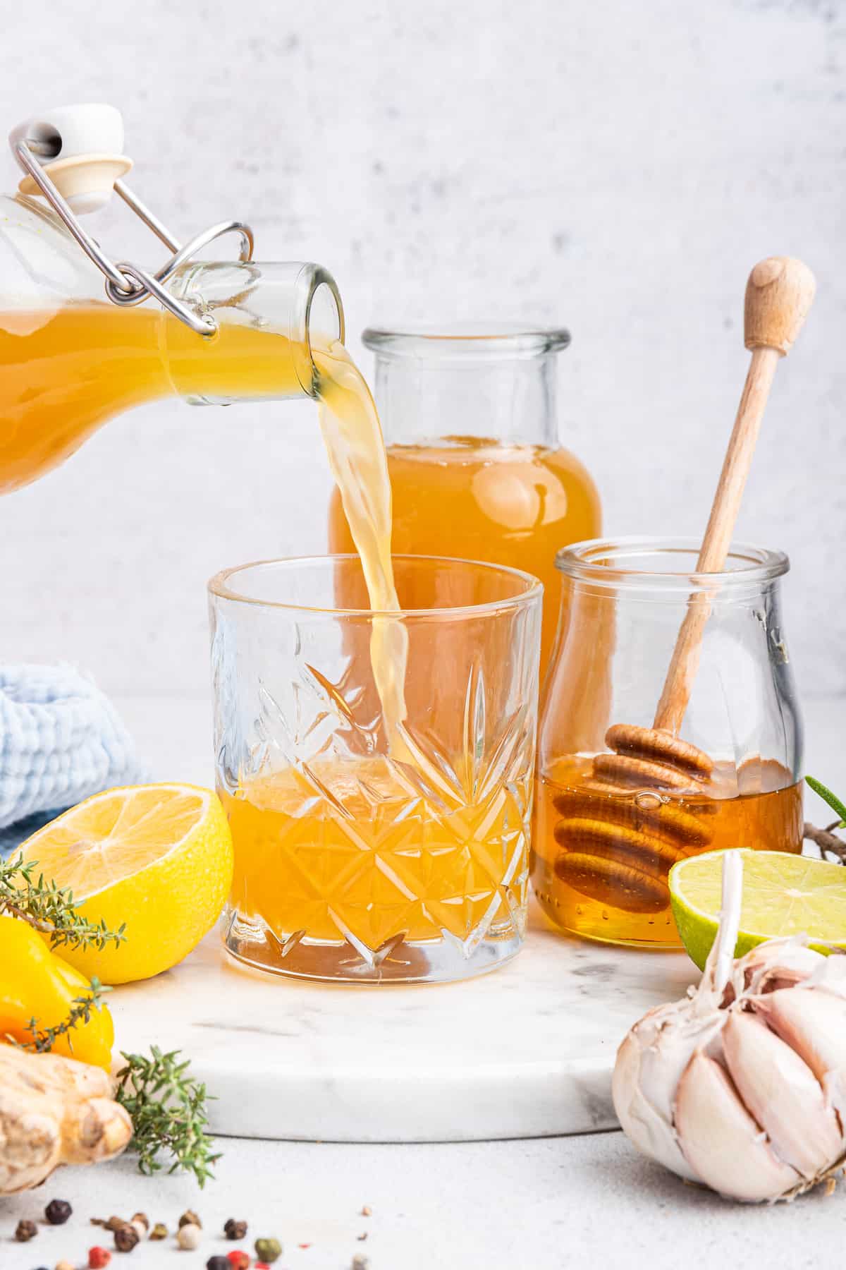 Pouring fire cider from bottle into glass
