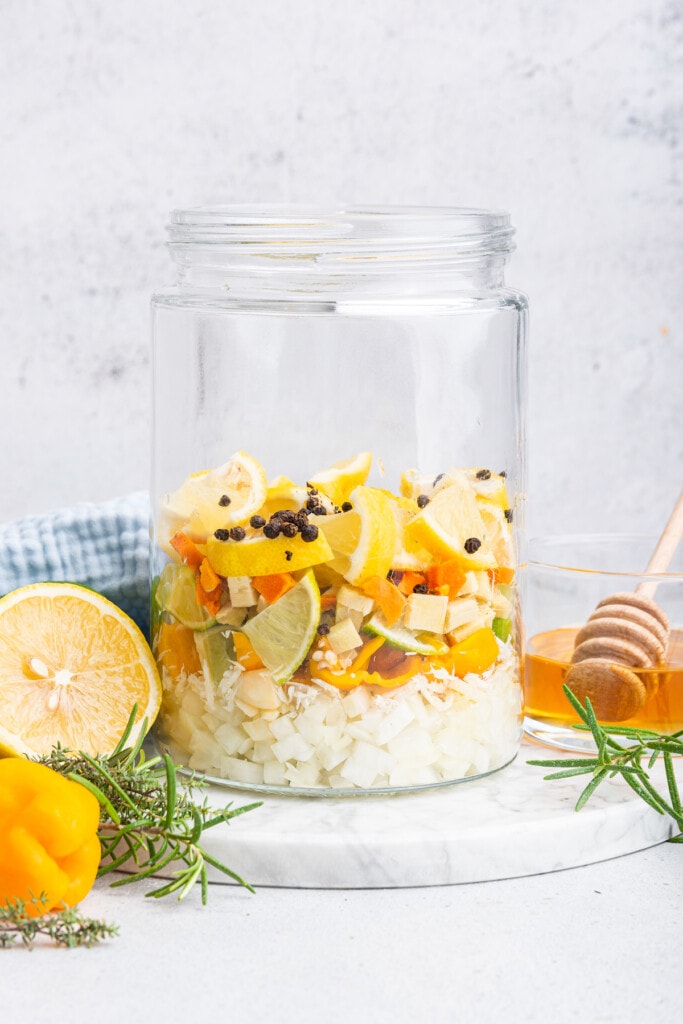 Ingredients for fire cider layered in jar