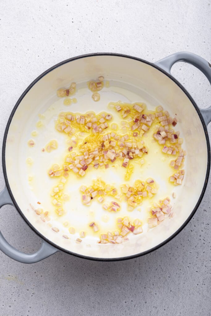 Overhead view of sauteed shallots in pot