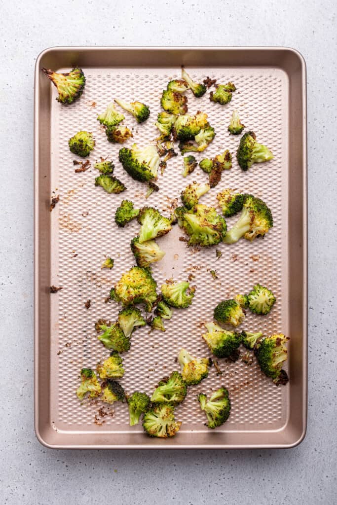 Overhead view of roasted broccoli on sheet pan