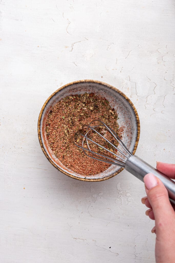 Overhead view of seasoning for chicken in small bowl