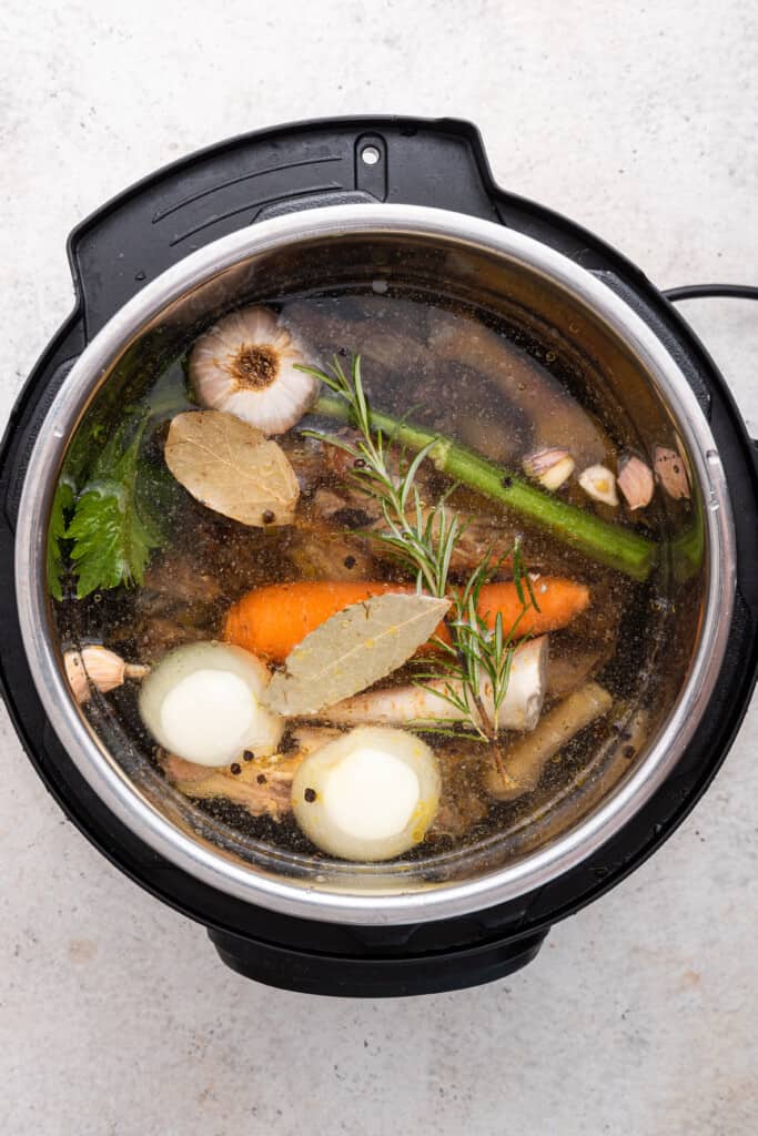 Overhead view of ingredients for Instant Pot chicken bone broth in IP